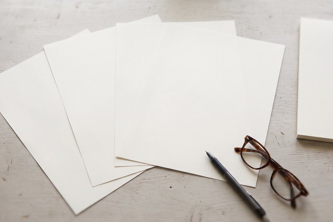 Blank shipping paperwork fanned across a desk while a consignment is planned