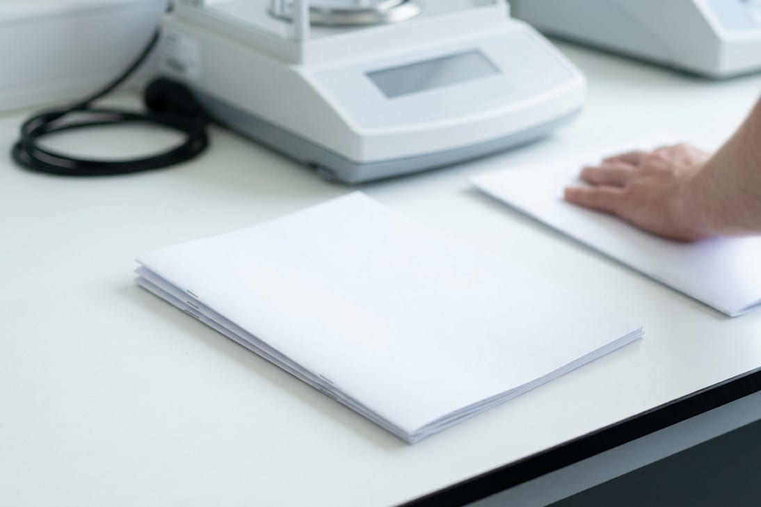 Two test report sets on a laboratory bench, one squared up and one pushed aside